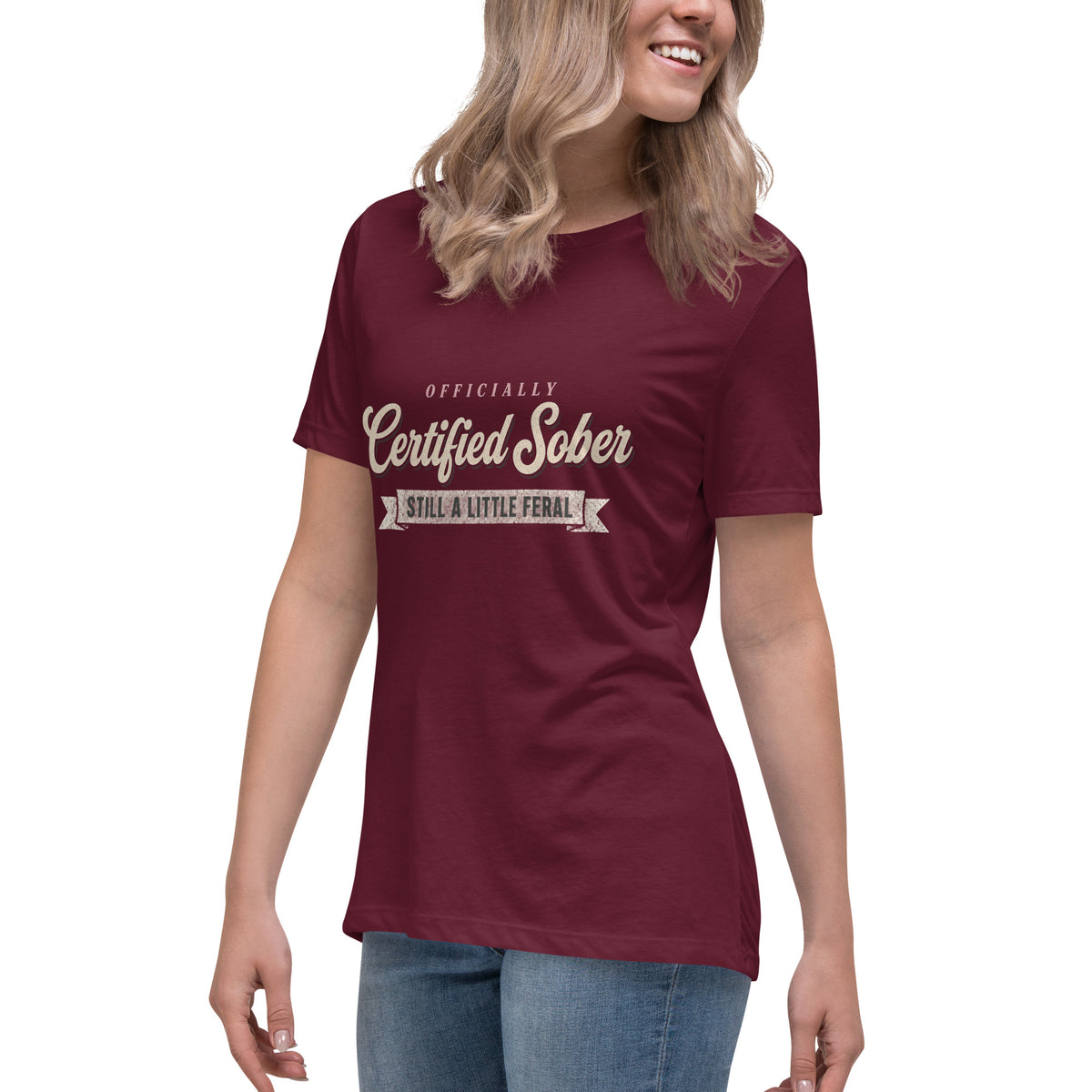 Woman wearing the maroon Certified Sober, Still a Little Feral relaxed tee, side view